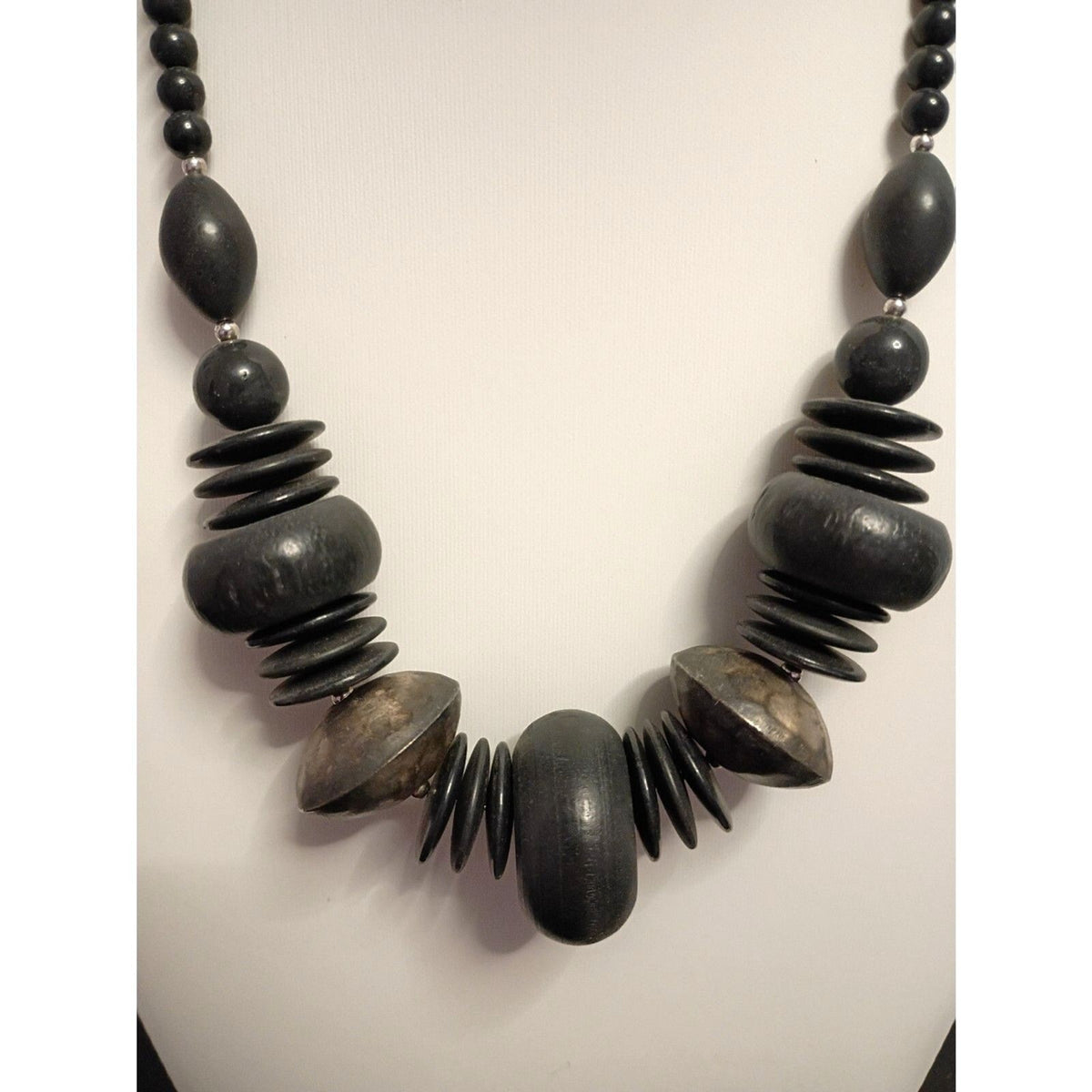 Vintage signed Monet Necklace of Various Shapes of Wooden beads also large Metal