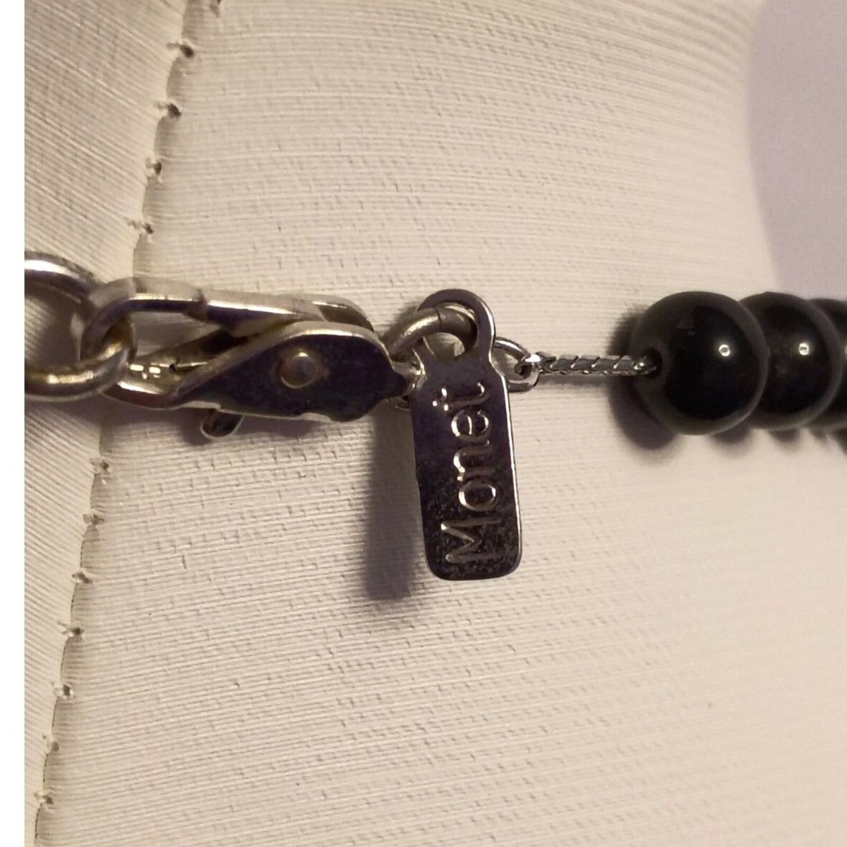 Vintage signed Monet Necklace of Various Shapes of Wooden beads also large Metal